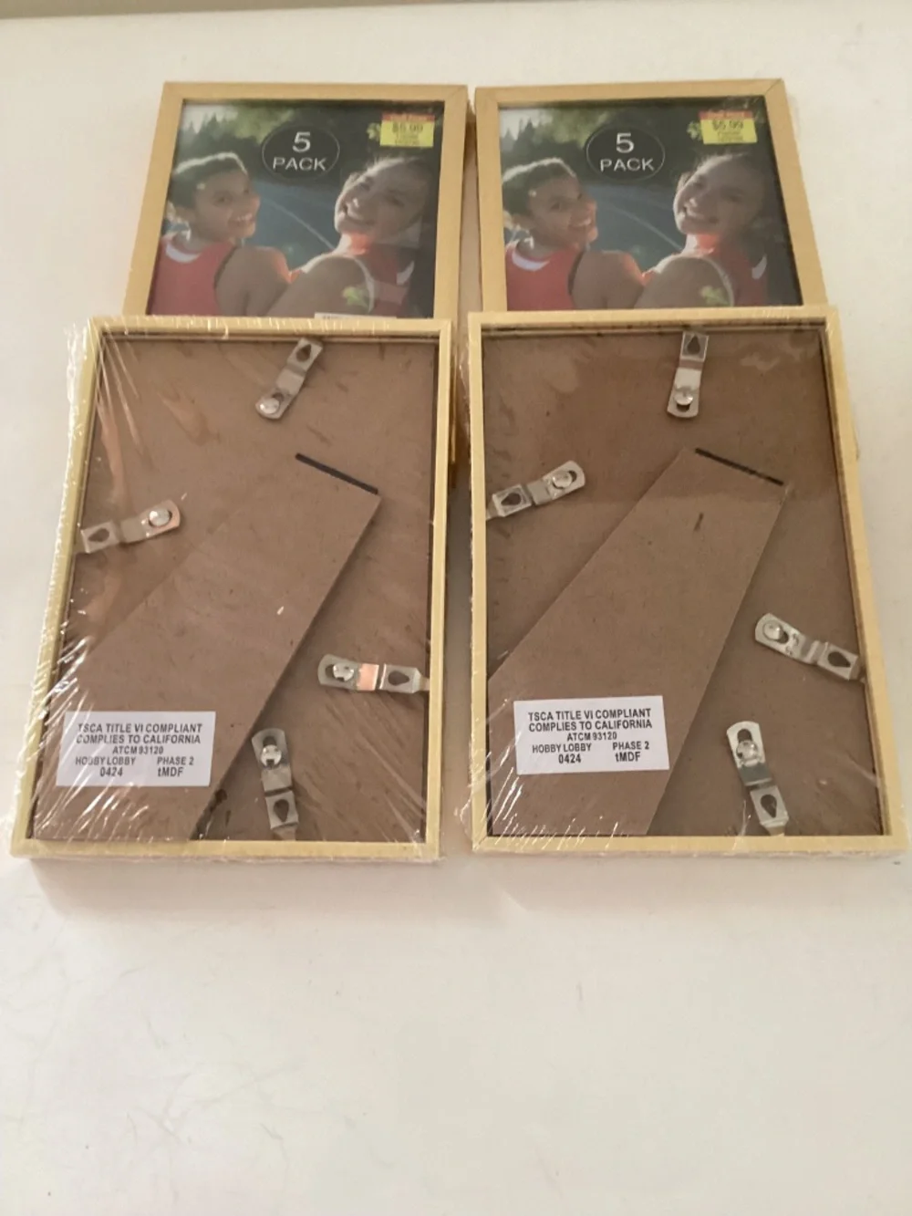 5 4x6 inch brass photo frames, 4 new/old stock in pkg. one pre owned
